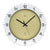 Beige Wanduhr mit schwarzem Ziffernring und schwarzen Zeigern, rund, mit AMS-Logo