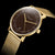 Sternglas Herrenuhr mit braunem Zifferblatt und goldfarbenem Metallarmband