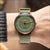 Unisex-Uhr mit grünem Zifferblatt und olivfarbenem Textilarmband, kupferfarben.