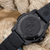 Herrenuhr mit schwarzem Carbonox-Armband und Sichtboden mit Navy-Seal-Logo