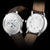 Sternglas Herrenuhr Vorder- und Rückseite, braunes Lederarmband, silberfarbenes Gehäuse.
