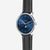 Herrenuhr mit blauem Zifferblatt und mehreren Zeigern, schwarzes Lederarmband.