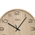 Wanduhr mit Holzgehäuse, schwarze Zeiger, braune Ziffern und AMS-Logo