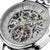 Herrenuhr mit Skelett-Zifferblatt, goldenen Zeigern und blauen Akzenten