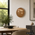 Wanduhr: runde LED-Wortuhr im Kupfer-Look mit beleuchteter Schrift an der Wand.