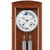 Holzwanduhr mit Glasfront, braunem Gehäuse, rundem Zifferblatt und Pendel